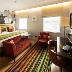 Day use room with lounge seating and work desk at Indigo London-Paddington Hotel.