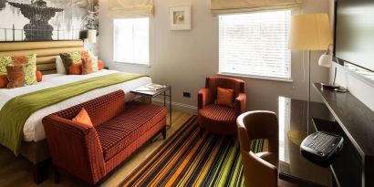 Day use room with lounge seating and work desk at Indigo London-Paddington Hotel.