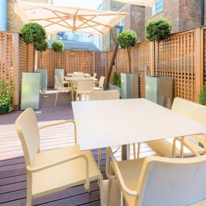 Beautiful outdoor patio with sitting area at Indigo London-Paddington Hotel.