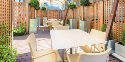 Beautiful outdoor patio with sitting area at Indigo London-Paddington Hotel.