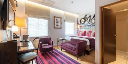 Day use room with work desk and lounge seating at Indigo London-Paddington Hotel.