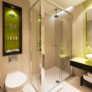 Guest bathroom with shower and free toiletries at Indigo London-Paddington Hotel.