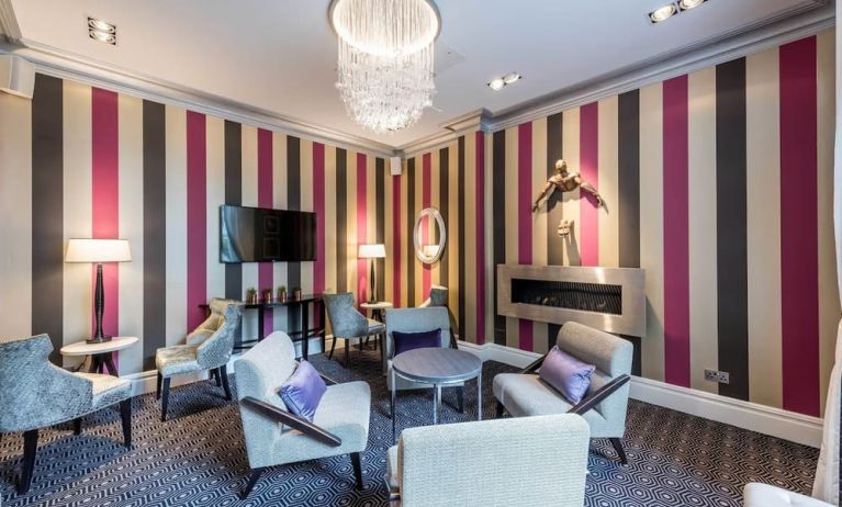 Lounge area with comfortable seating and fireplace at Mercure London Hyde Park Hotel.