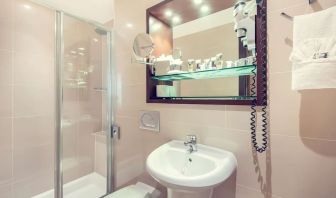 Private bathroom with tub and free toiletries at Mercure London Paddington Hotel.