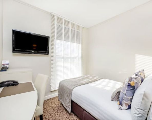 Bright day use room with TV screen, work desk and private bathroom at Mercure London Paddington Hotel.