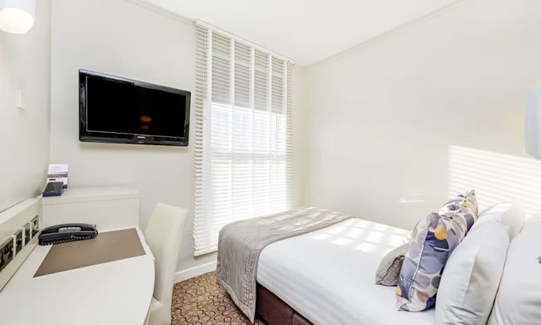 Bright day use room with TV screen, work desk and private bathroom at Mercure London Paddington Hotel.