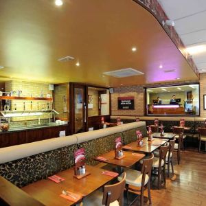 Dining area with comfortable seating at Mercure London Paddington Hotel.