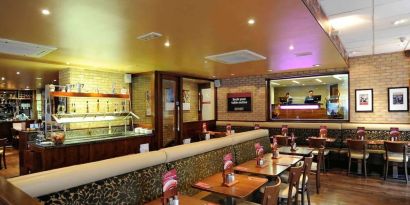 Dining area with comfortable seating at Mercure London Paddington Hotel.