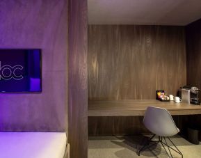 In-room workspace with comfortable seating and coffee maker at BLOC Gatwick Hotel.