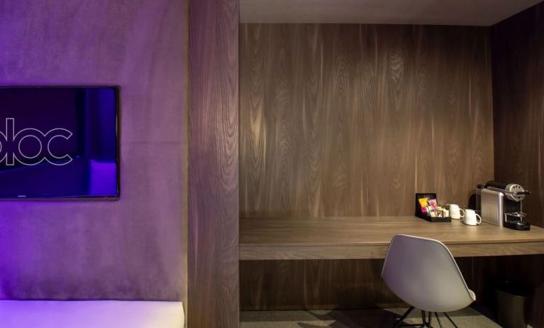 In-room workspace with comfortable seating and coffee maker at BLOC Gatwick Hotel.