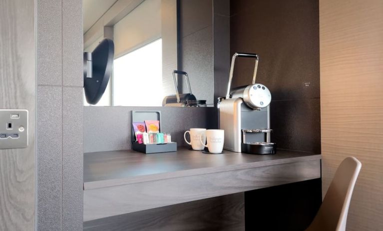 Room work desk with coffee and tea machine at BLOC Gatwick Hotel.