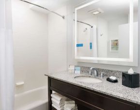 Guest bathroom with shower and tub at Hampton Inn Washington DC / White House.