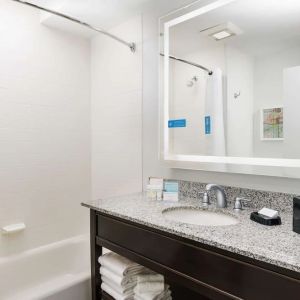 Guest bathroom with shower and tub at Hampton Inn Washington DC / White House.