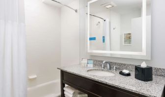 Guest bathroom with shower and tub at Hampton Inn Washington DC / White House.