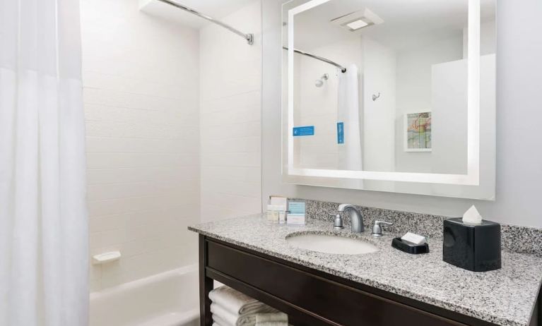 Guest bathroom with shower and tub at Hampton Inn Washington DC / White House.