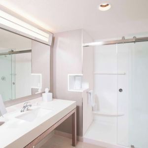 Guest bathroom with shower at Courtyard By Marriott Redwood City.