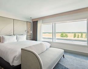 Day use room with TV screen, sofa and private bathroom at Hyatt Place London Heathrow Airport.