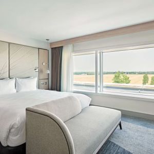 Day use room with TV screen, sofa and private bathroom at Hyatt Place London Heathrow Airport.