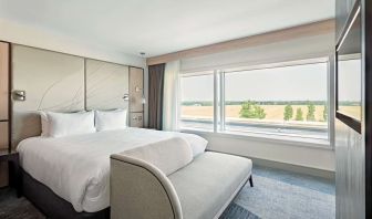 Day use room with TV screen, sofa and private bathroom at Hyatt Place London Heathrow Airport.