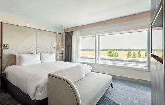 Day use room with TV screen, sofa and private bathroom at Hyatt Place London Heathrow Airport.