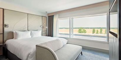 Day use room with TV screen, sofa and private bathroom at Hyatt Place London Heathrow Airport.