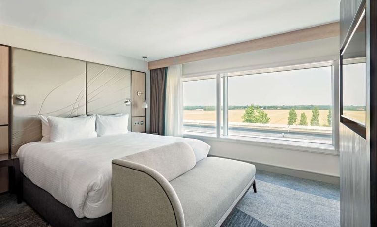 Day use room with TV screen, sofa and private bathroom at Hyatt Place London Heathrow Airport.