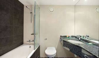 Private guest bathroom with combined tub/shower and free toiletries at Hyatt Place London Heathrow Airport.