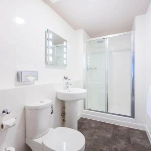 Guest bathroom with shower and free toiletries at Mercure Nottingham City Centre Hotel.