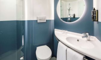 Private guest bathroom with shower and free toiletries at Ibis London Blackfriars Hotel.