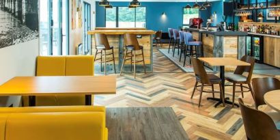 Dining area with comfortable seating, perfect for co-working at Ibis Plymouth.