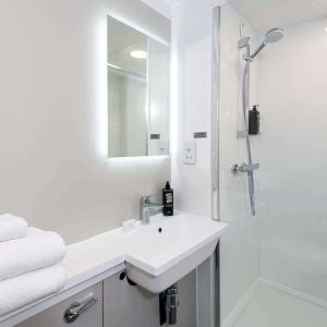 Private guest bathroom with shower at Ibis Plymouth.