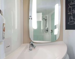 Private guest bathroom with shower at ibis Sheffield City.