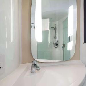 Private guest bathroom with shower at ibis Sheffield City.