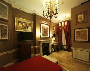 Day use room with work desk and fireplace at Opulence Central London Hotel.