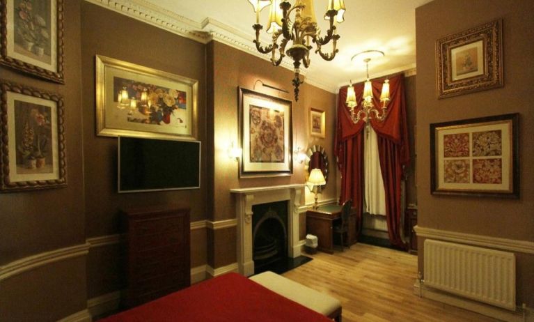 Day use room with work desk and fireplace at Opulence Central London Hotel.