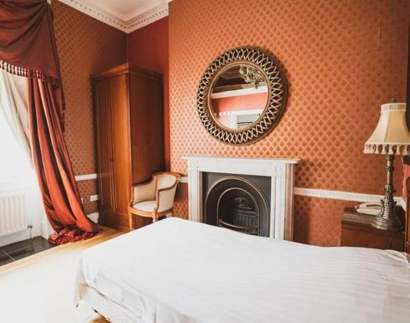 Bright and spacious day use room with fireplace at Opulence Central London Hotel.