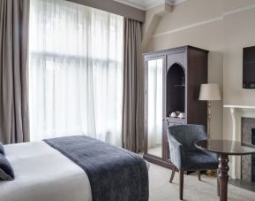 Day use king room with floor to ceiling window, fireplace and workspace at St Paul's Hotel.