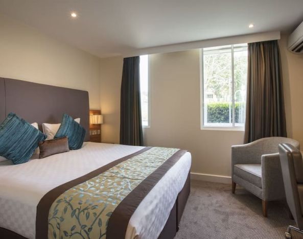 Day use room with lounge seating and work desk at Thistle London Heathrow Terminal 5 Hotel.