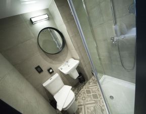 Guest bathroom with shower at The House Of Toby Hotel.