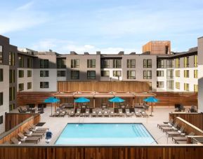 Loungers around outdoor pool at Embassy Suites Boulder.
