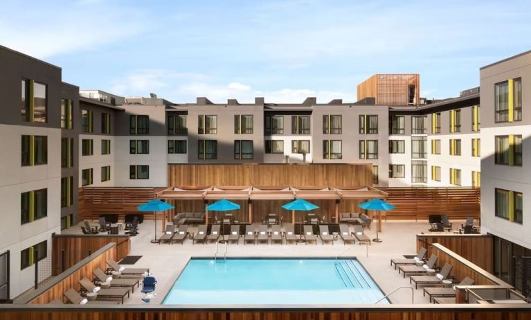 Loungers around outdoor pool at Embassy Suites Boulder.
