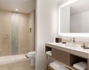 Guest bathroom with shower at Embassy Suites Boulder.
