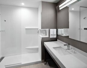 Guest bathroom with shower at Courtyard Delray Beach.
