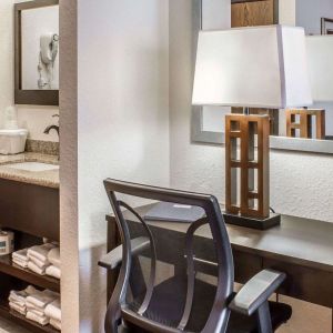 Work desk and guest bathroom at Rodeway Inn Milford.