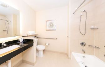 Guest bathroom with shower at Best Western San Diego Zoo/SeaWorld Inn & Suites.