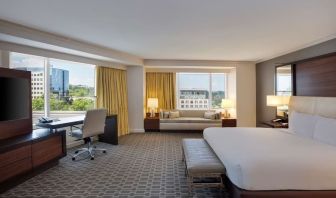 Spacious day use room with work desk and sofa at Hilton McLean Tysons Corner.