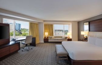 Spacious day use room with work desk and sofa at Hilton McLean Tysons Corner.