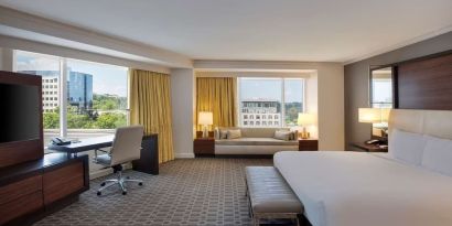 Spacious day use room with work desk and sofa at Hilton McLean Tysons Corner.