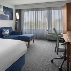 Day use room with sofa and work desk at Courtyard By Marriott Cypress Anaheim.