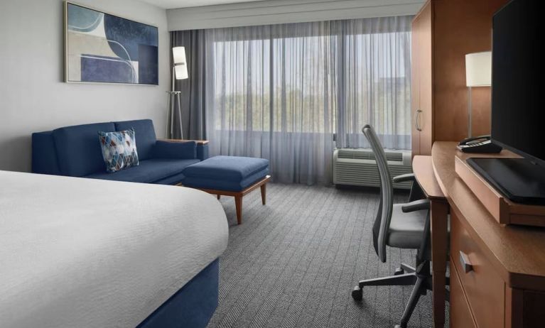 Day use room with sofa and work desk at Courtyard By Marriott Cypress Anaheim.